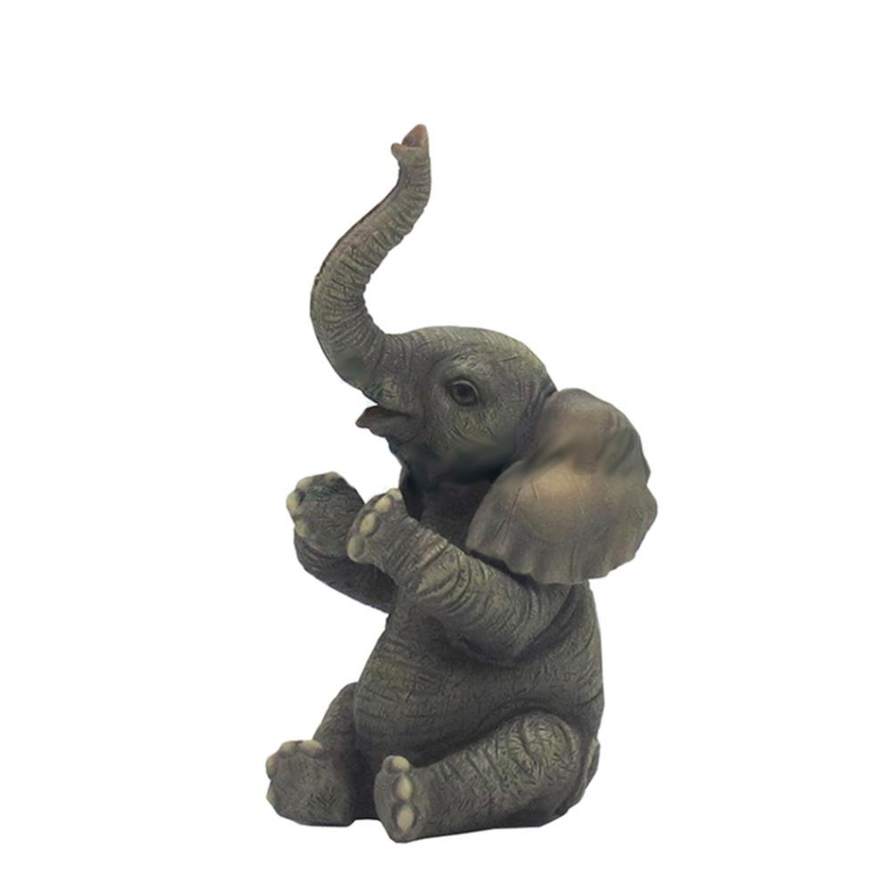 Сидящий слон с поднятым хоботом